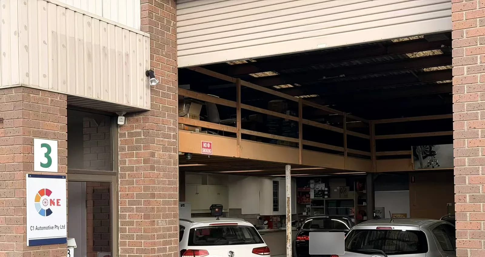C1 Automotive workshop entrance and installation bay in Oakleigh South with number plates redacted