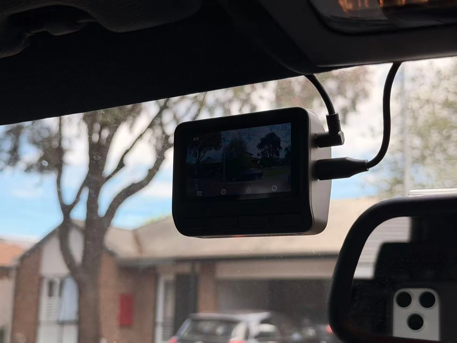 DDPAI Z60 front dash cam installed beside the rear-view mirror in a BMW X3