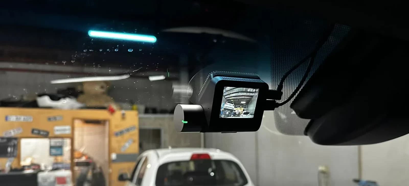 Front dash cam on a Lexus LX showing live recording screen with workshop interior