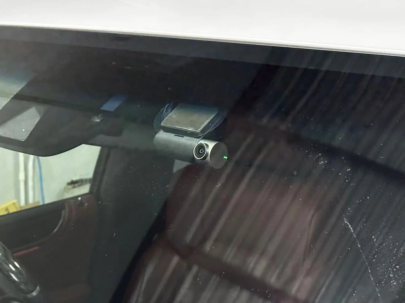 Front dash cam visible at the top of the windscreen on a Lexus LX, viewed from outside