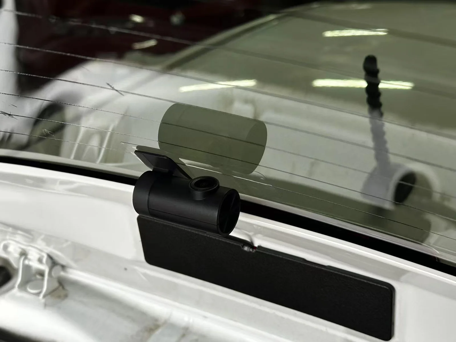 Rear dash cam mounted at the top of the rear windscreen on a Toyota Yaris