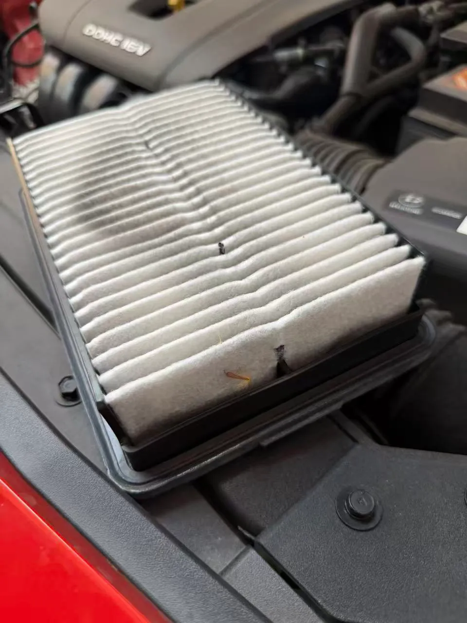 Engine air filter taken out of the airbox of a Hyundai Kona to check its condition