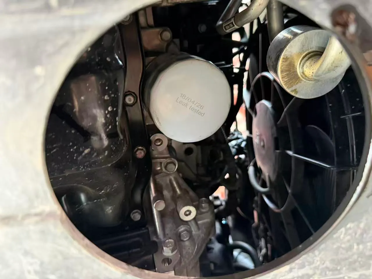 New oil filter fitted to the Hyundai Kona engine, seen through the undertray access panel