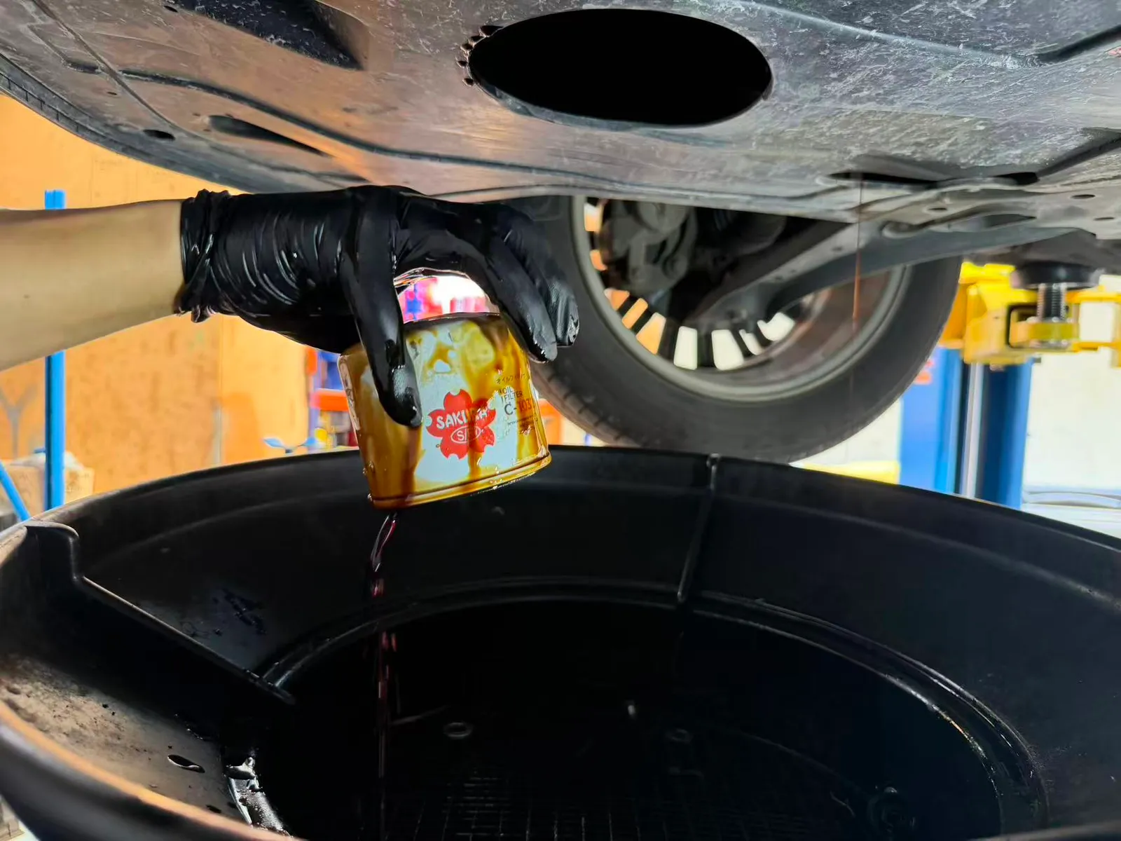 Used oil filter removed from a Hyundai Kona and drained into the oil tray