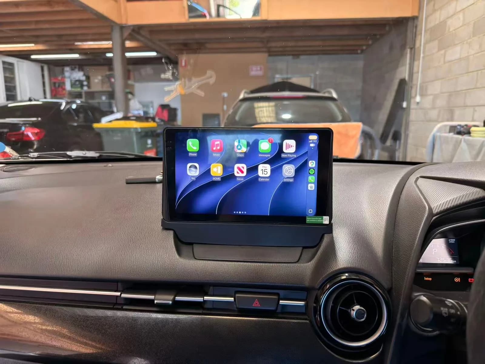 9-inch wireless Apple CarPlay screen fitted in the factory screen position on the dash of a 2015 Mazda2