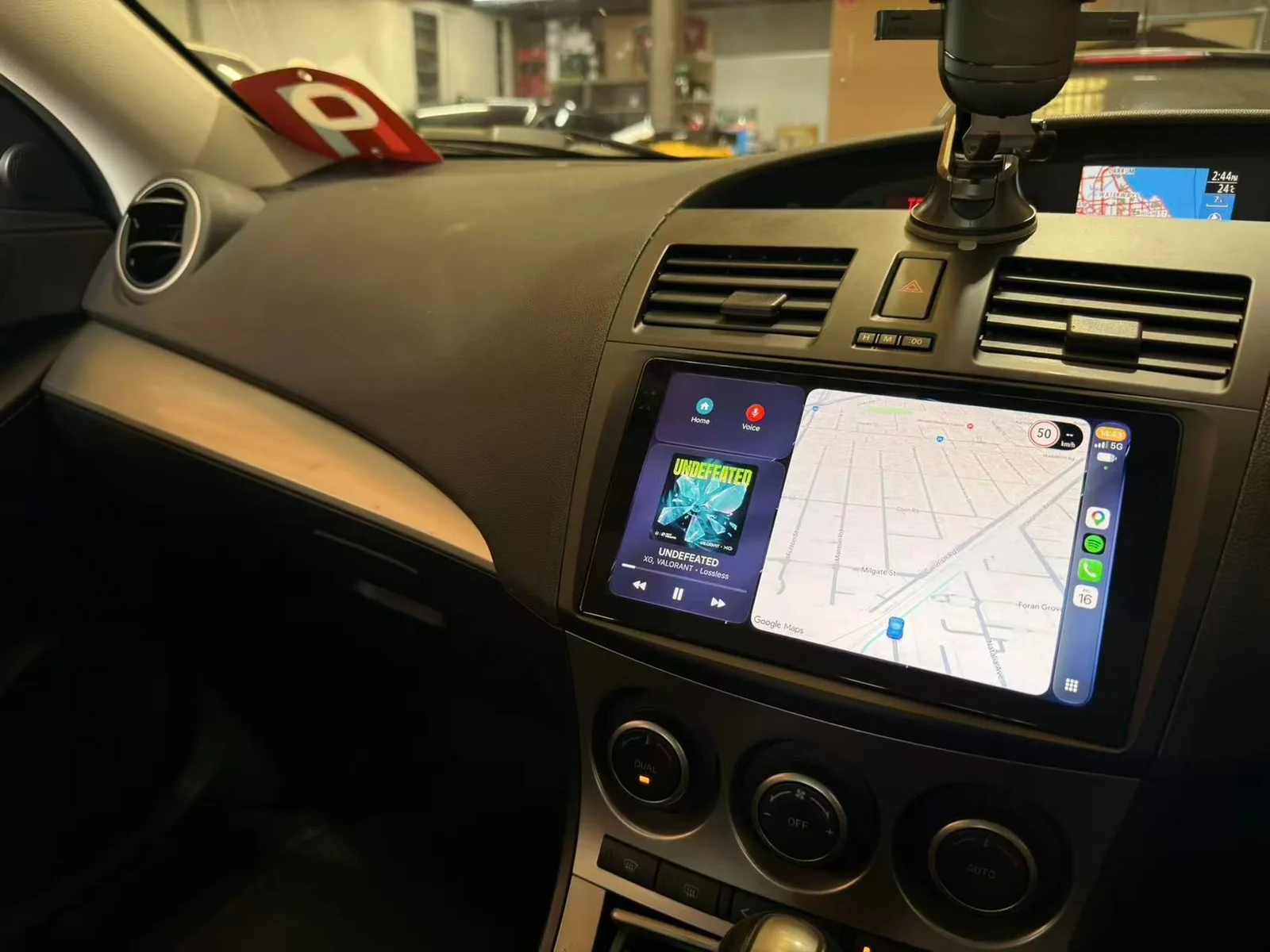 Apple CarPlay split screen with Google Maps beside the music player on the new head unit in a 2010 Mazda3