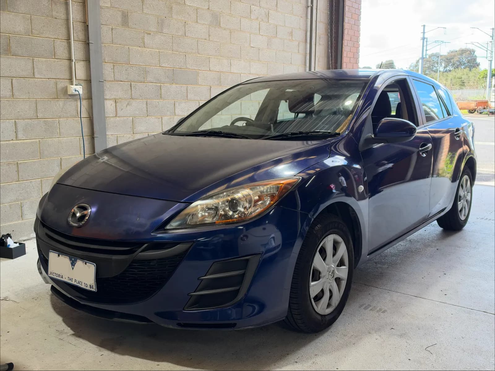 Blue 2011 Mazda3 hatch at the C1 Automotive workshop in Oakleigh South, number plate redacted