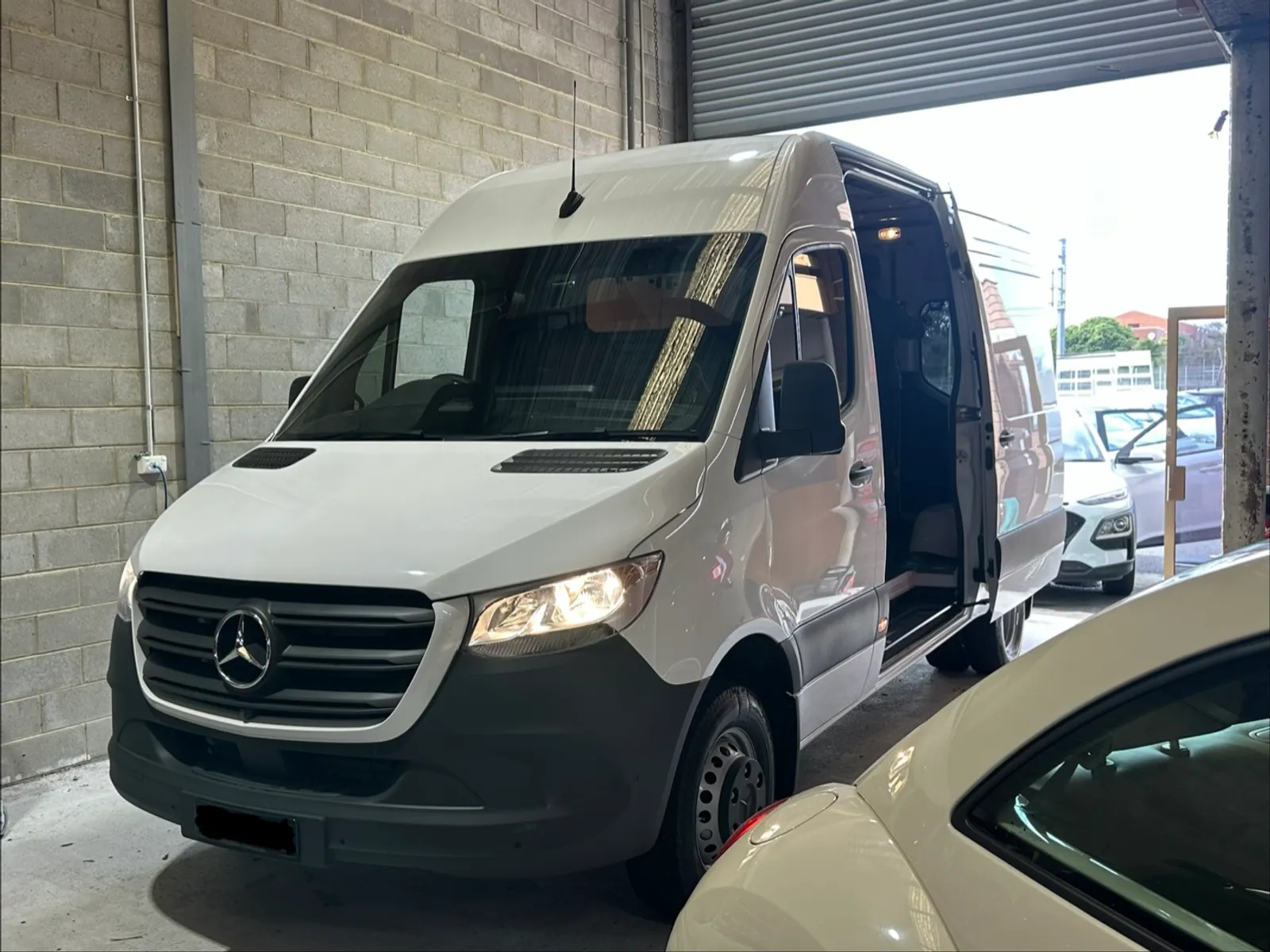 Mercedes-Benz Sprinter van in the C1 Automotive workshop in Melbourne for a four-channel dash cam installation, with the number plate redacted