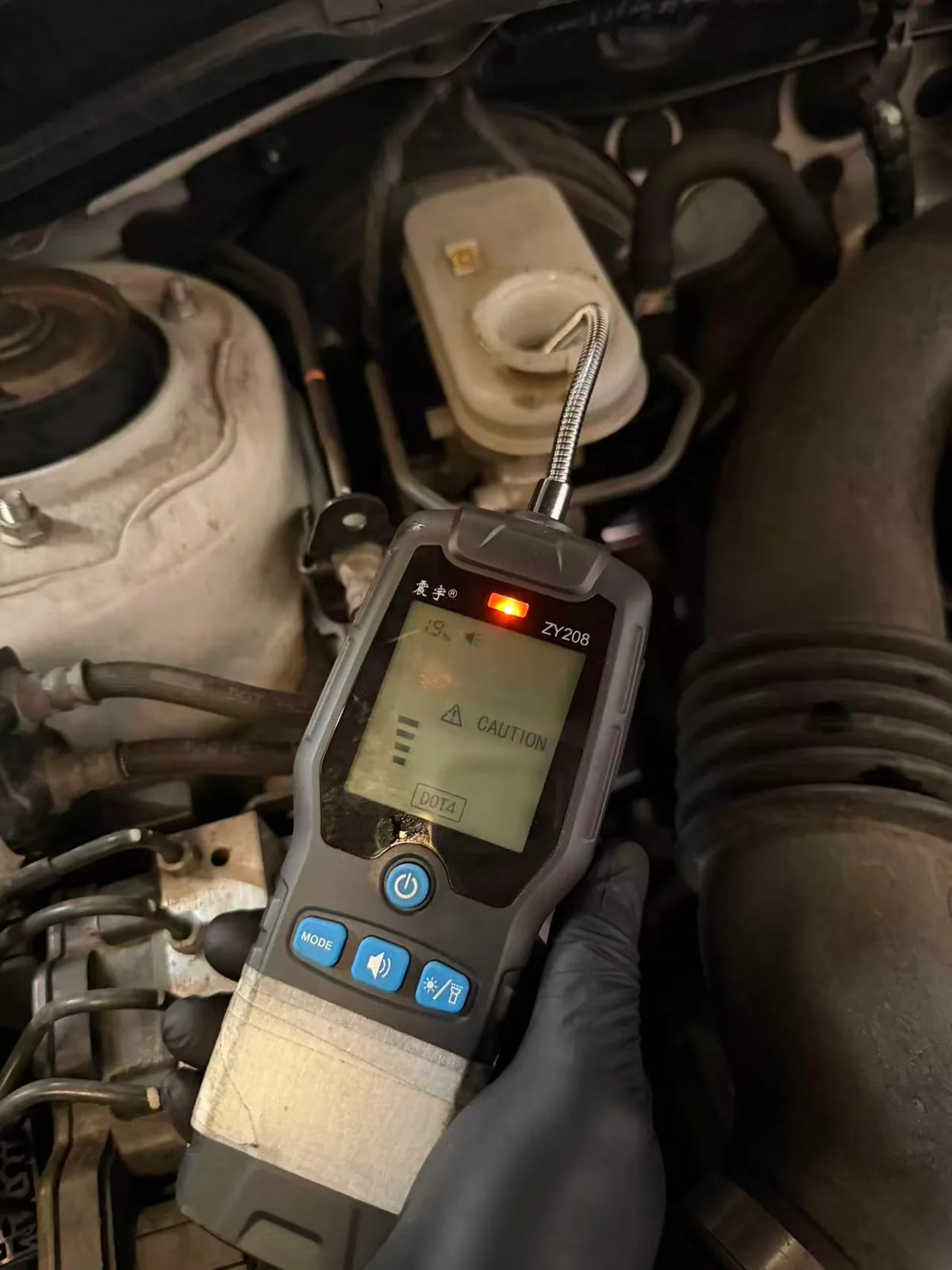 Subaru Forester brake fluid condition being checked with an electronic DOT 4 fluid tester