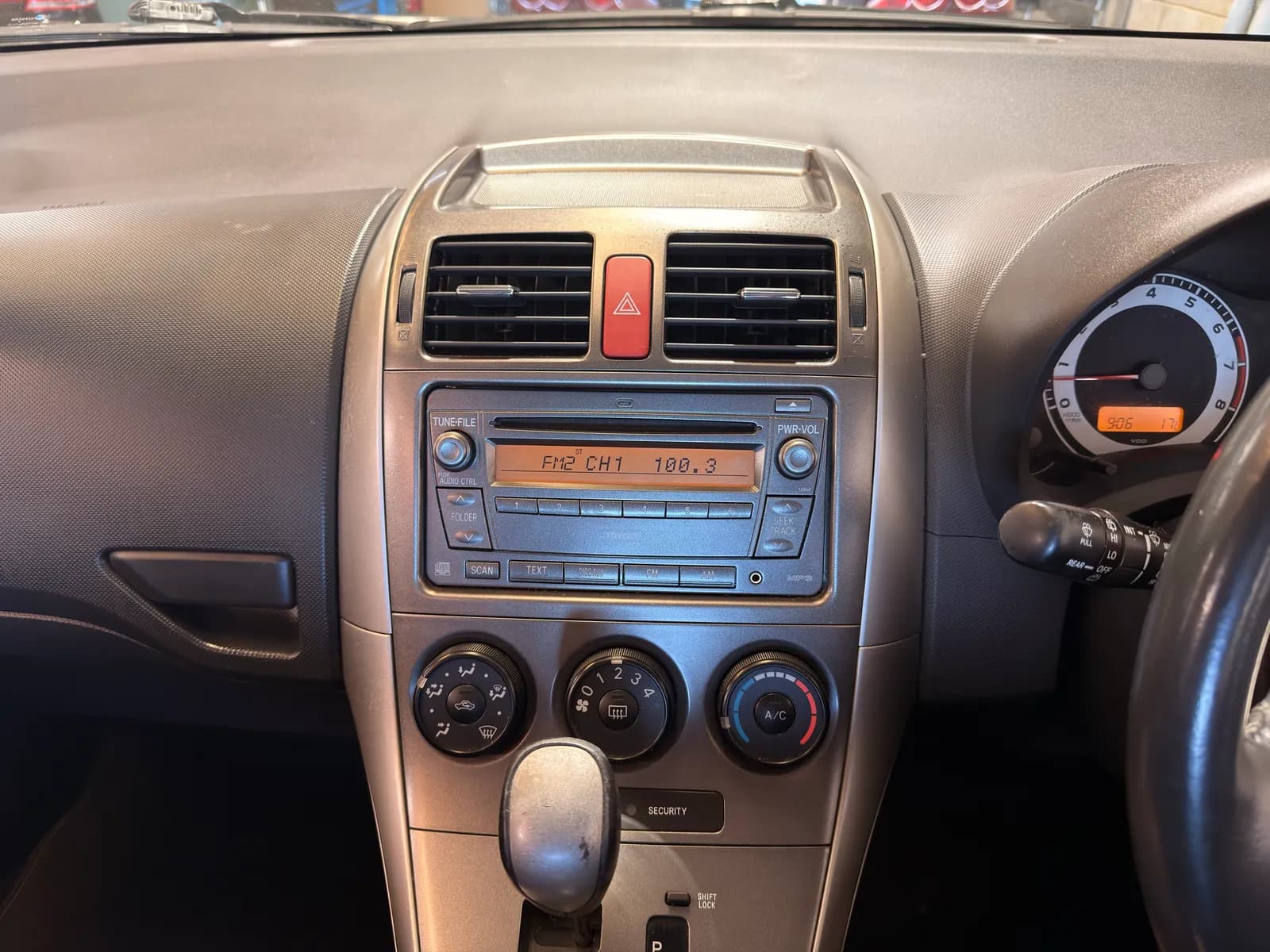The factory radio in a 2009 Toyota Corolla before the CarPlay upgrade