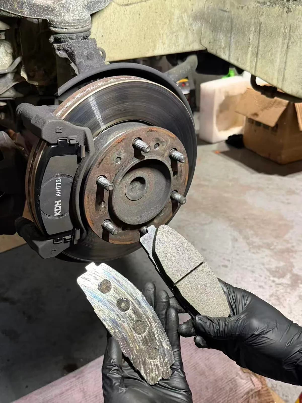 Old and new Toyota HiAce front brake pads compared during brake replacement
